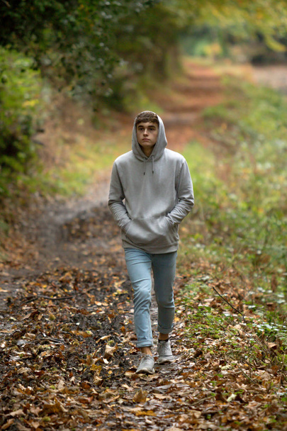 Teenage boy walking alone on an atumn day - Фото, изображение