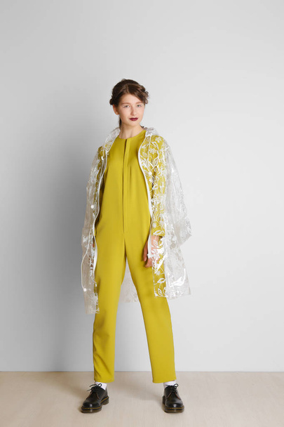 Pretty young girl in yellow overalls and PVC raincoat - Zdjęcie, obraz