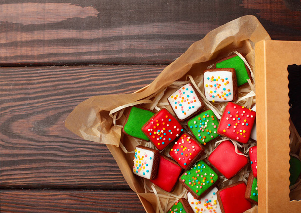 Open box Christmas different colour cookies on a old wooden table.Copy space - Фото, зображення