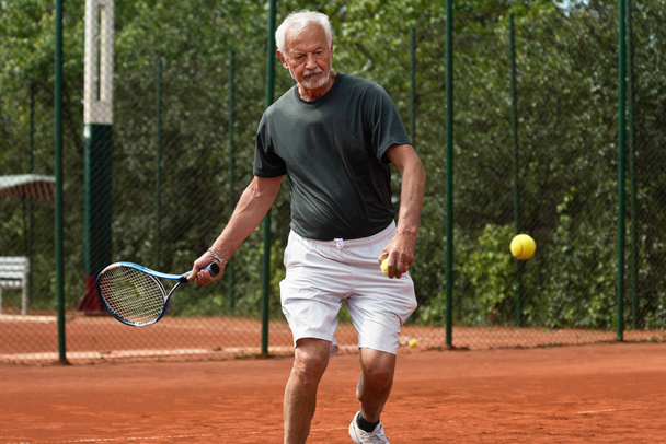 Senior tennis player playing tennis - Photo, Image