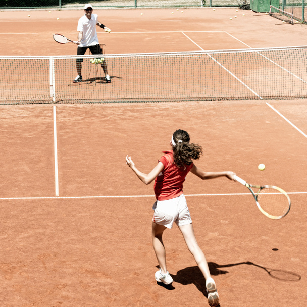 girl playing tennis with coach - Photo, Image