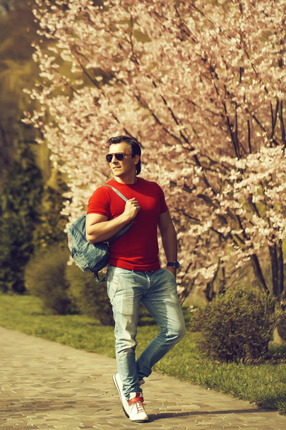 Stylish man ner blooming tree - Zdjęcie, obraz
