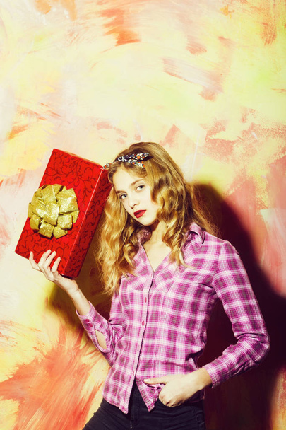 Pretty girl with red gift box with golden bow - Foto, Bild