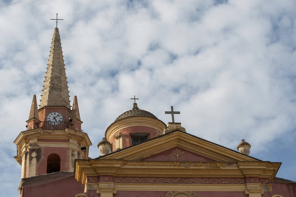 Korsika, 03 / 09 / 2017: Blick auf die Kirche der hl. Maria von Calvi, die rosa und gelbe katholische Kirche, die der Jungfrau Maria gewidmet ist, im Zentrum der thronenden und antiken Zitadelle von Calvi - Foto, Bild