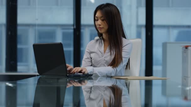 4K Portrait smiling businesswoman working on laptop at her desk. - Felvétel, videó
