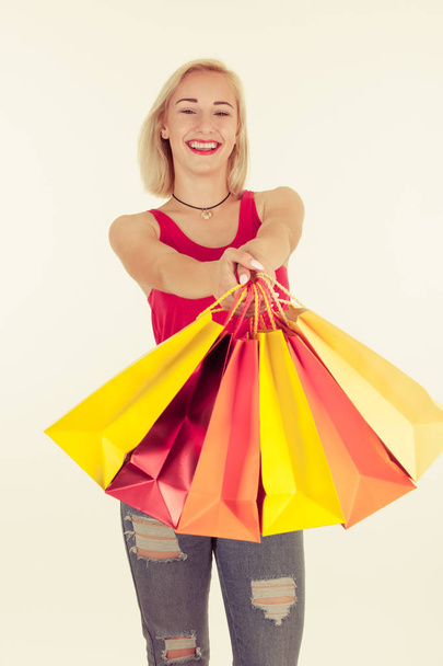 Attractive blonde young woman with shopping bags isolated - Zdjęcie, obraz