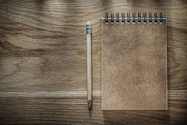 Pencil brown notebook on wooden board - 写真・画像