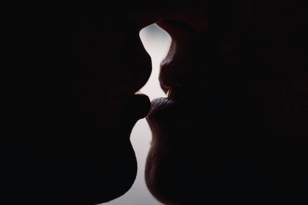 Guy and girl kiss large lips lips silhouettes. The guy is kissing the girl. - Foto, Imagen