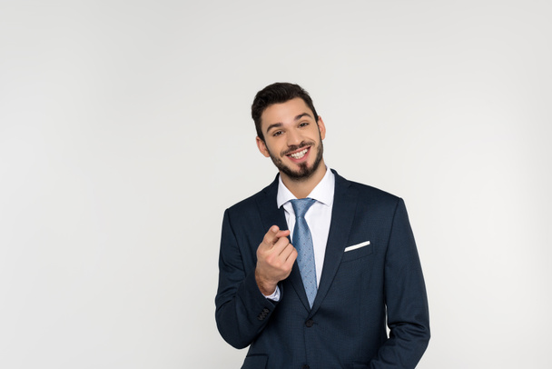 cheerful young businessman pointing at camera isolated on grey  - Foto, Bild
