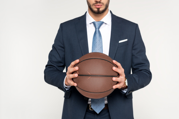 recortado disparo de joven empresario sosteniendo pelota de baloncesto aislado en gris
 - Foto, imagen