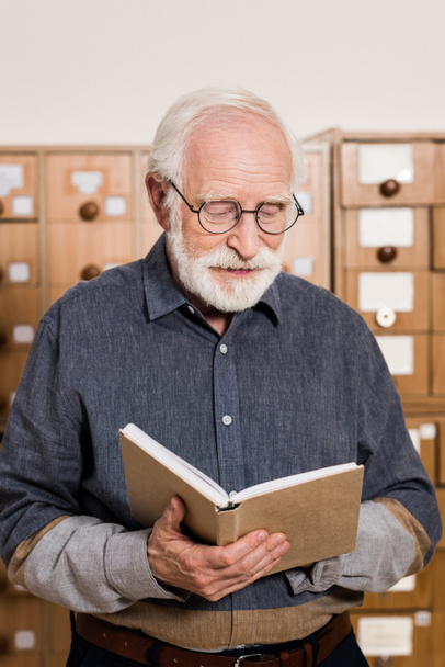 senior male archivist reading book - Fotoğraf, Görsel