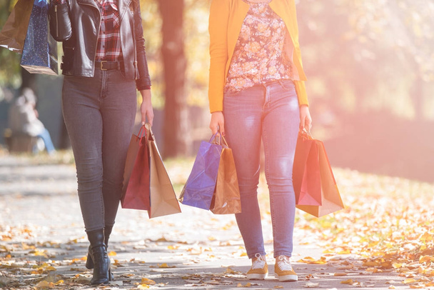 Happy girls shopping in late autumn. bags, walking, holidays - Foto, Bild