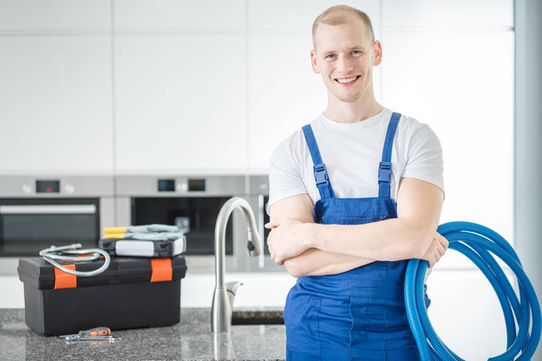 Smiling plumber with blue pipes - Fotó, kép