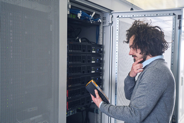 Young technician working  in server room - Photo, Image