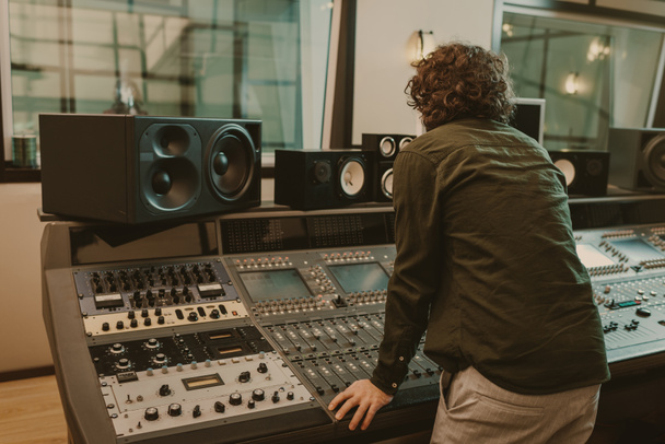 young sound producer working at recording studio - Fotografie, Obrázek