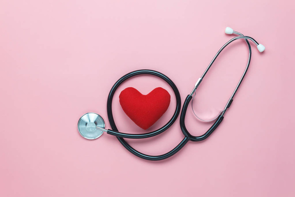 Table top view shot of arrangement equipment medical background concept.Red heart & stethoscope on modern rustic pink paper.An idea essential accessories for doctor for  care patient  in hospital. - 写真・画像