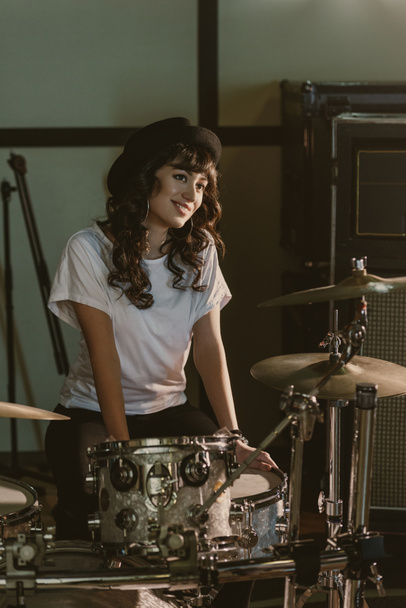attractive female drummer sitting at drum set - Photo, Image