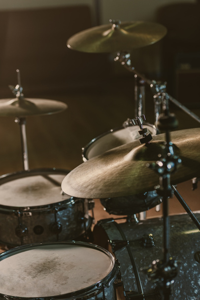 close-up shot of drum set under spotlight on stage - Fotografie, Obrázek