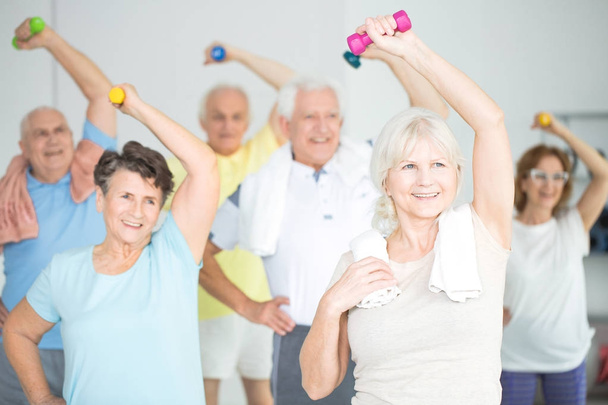 Seniors doing strength building exercises - Фото, изображение