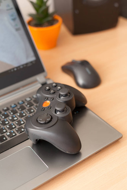 A close-up of the gamepad lying on the laptop. - Photo, Image
