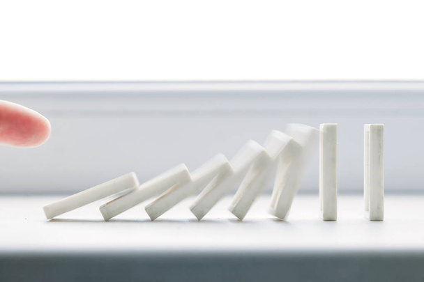 White domino, domino principle, on white background - Фото, изображение