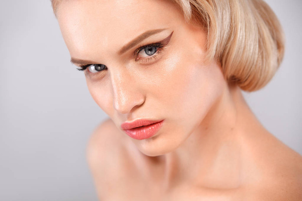 Closeup portrait of beautiful young woman with clean and fresh skin. Nude makeup. Facial treatment . Concept for cosmetology, beauty and spa . - Valokuva, kuva