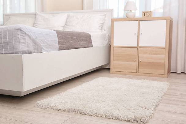 Modern bedroom interior with soft fluffy carpet - Фото, изображение