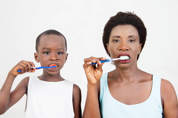 Mutter und Kind putzen sich jeden Morgen gemeinsam die Zähne. - Foto, Bild