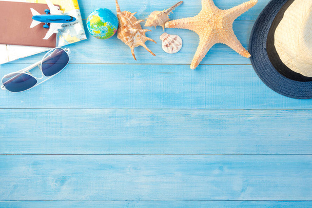 top view of travel accessories on light blue wood plank floor fo - Fotografie, Obrázek