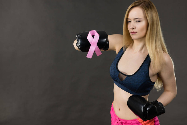 Woman wearing boxing gloves having pink ribbon - Foto, Imagen