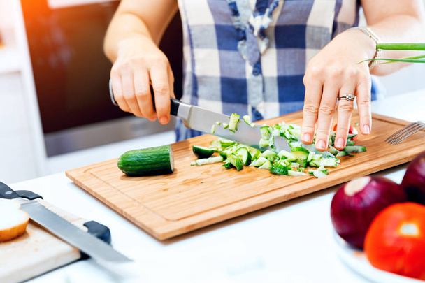 Female hands cutting cucumbers - Photo, Image