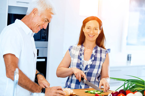 Married couple cooking at home - 写真・画像
