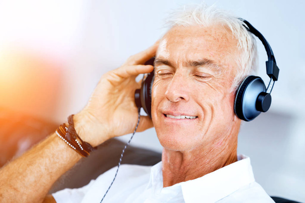 Handsome gray haired senior man with headphones - Fotografie, Obrázek