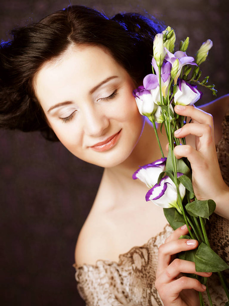 beautiful brunette woman with lilac flowers - Fotografie, Obrázek