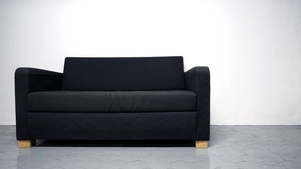 Sofá de cor preta feita de madeira e tecido
 - Foto, Imagem