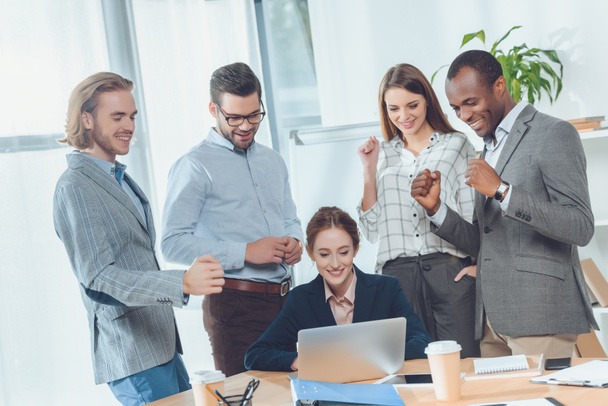 business team standing against sitting woman at office space   - Fotoğraf, Görsel