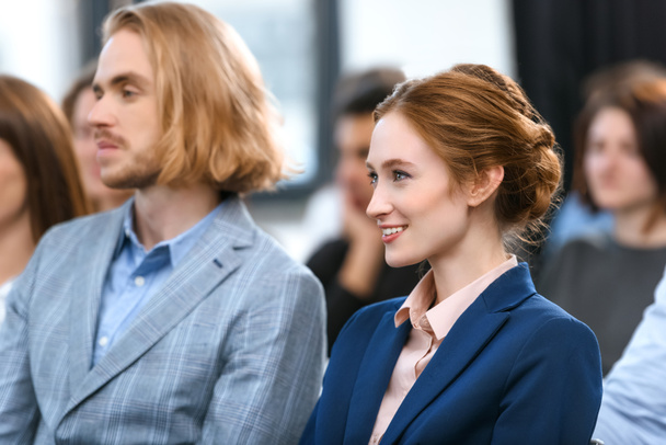 man and woman in formal suits sitting near each other at meeting - Фото, зображення