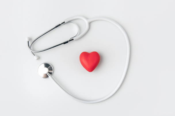 stethoscope with red heart laying isolated on white background     - Photo, Image