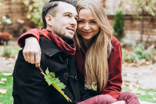 young beautiful couple posing outdoors in autumn  - Photo, Image