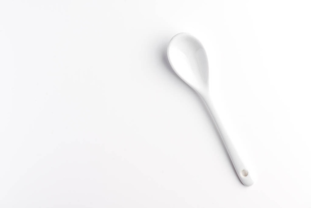 White spoon isolated on a white surface - Фото, зображення
