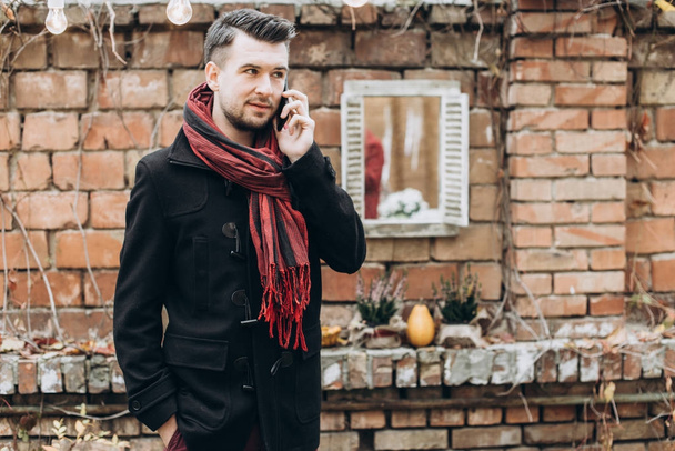 young handsome man talking on phone outdoors  - Fotografie, Obrázek
