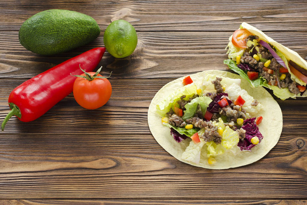 tacos  and ingredients on wooden table - Photo, Image
