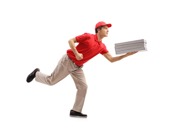 Teenage pizza delivery boy running - Фото, изображение