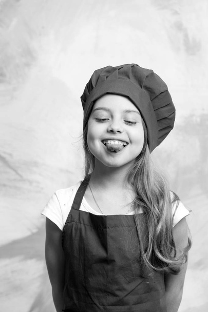 small girl chef with happy face in hat and apron - Foto, Imagem