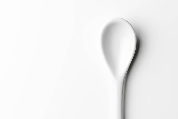 White spoon isolated on a white surface - Photo, Image