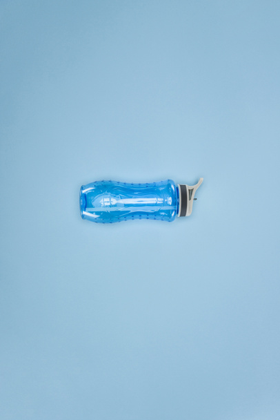 Sports water bottle isolated on blue background - Photo, Image
