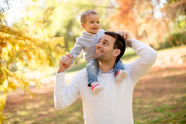 Young father and baby boy in autumn park - Foto, imagen