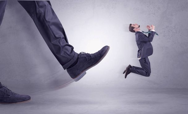 Foot kicking, businessman flying - Фото, изображение