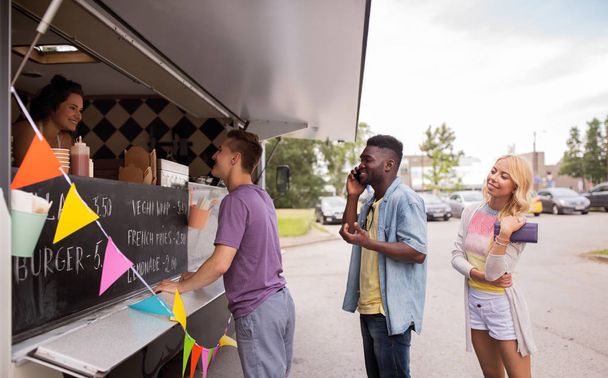 happy customers queue at food truck - Foto, immagini