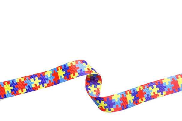 World Autism awareness and pride day with Puzzle pattern ribbon isolated on white - Fotoğraf, Görsel